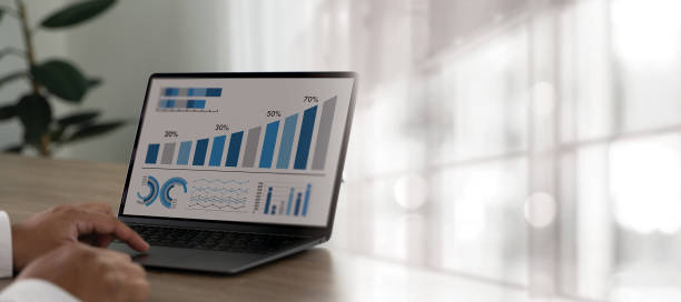 istock man use laptop finance market analyst in eyeglasses working Using KPI Data marketing analytic financial 1452462968