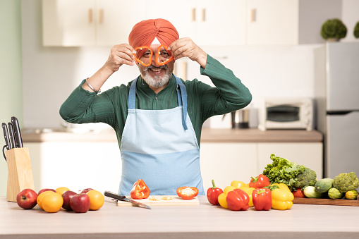 Mature Sikh Man With Turban In a Kitchen, stock photo