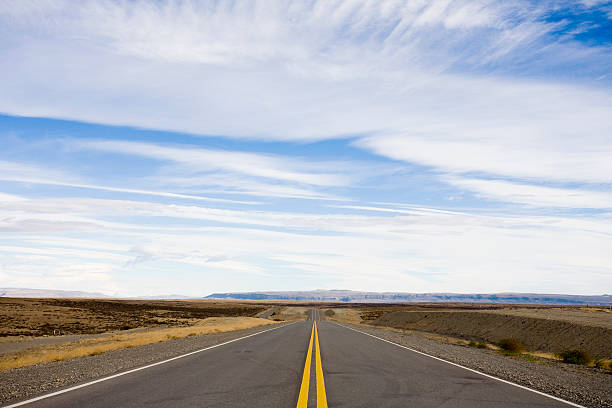 A long empty deserted road in America stock photo