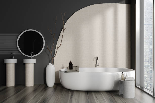 istock Dark bathroom interior with double sink and tub near window. Copy space 1452463965