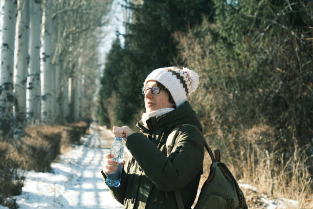 istock Woman is drinking water in winter park 1452463997