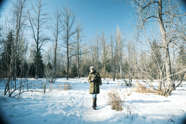 istock Woman is drinking water in winter park 1452464660