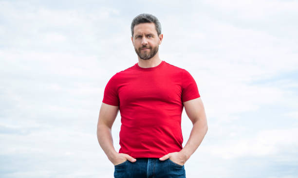 istock guy in red shirt outdoor on sky background 1452465307
