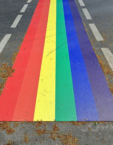 Pedestrian rainbow crossing on the Esplanade painted with the colors of the gay pride flag or LGBTQ banner in its 6-color version, standard since 1979. Cairns-Queensland-Australia.