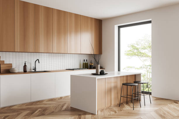 istock Light kitchen interior with bar countertop and seats near window, cooking space 1452465359