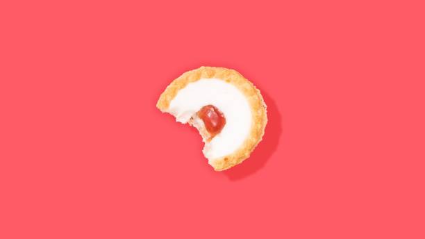istock Bitten cherry tart isolated on a pink background 1452465596
