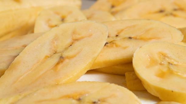 istock Close-up of cut bananas on a white table 1452465970