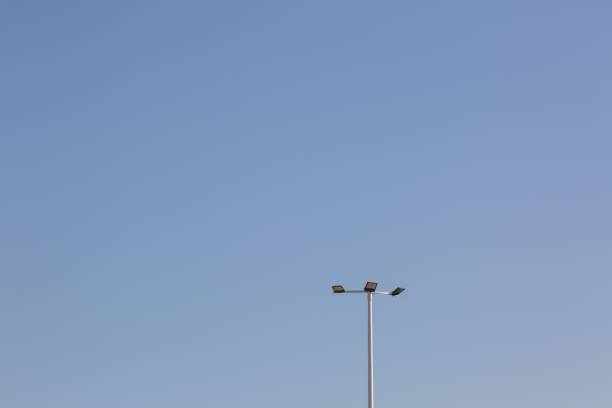 istock Closeup of a single street light against a blue sky 1452466873