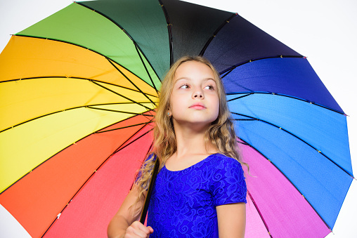 Under an rainbow colored umbrella on white background. 