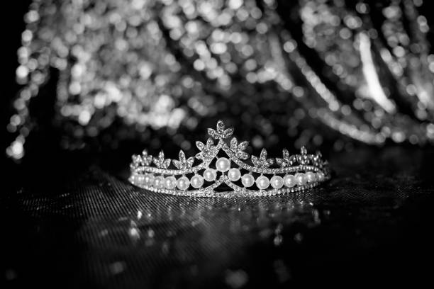 istock Diadem with pearls on bright sparkle background. Black and white. 1452467397
