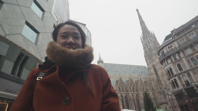 Woman take a photo in front of St. Stephens Cathedral, Vienna
