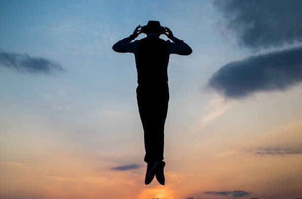 istock Break the rules. need the inspiration. man feel motivation. fly in sky. jumping man silhouette on sky background. confidence and success. concept of successful future. agile business. loneliness 1452468352