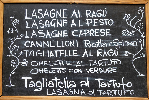 Lasagne al ragu on Menu in Florence at Tuscany, Italy, with an artistic drawing.