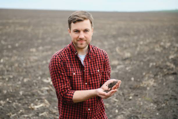 istock Soil in farmer arms. image with selective focus. 1452468433