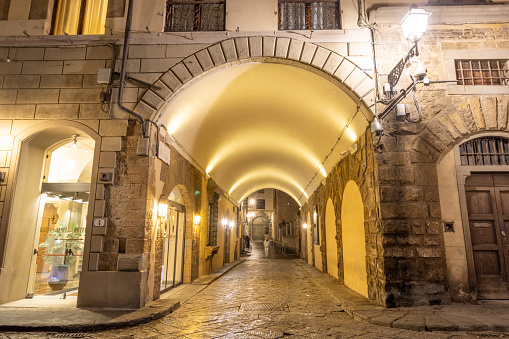 Alley in Florence at Tuscany, Italy, with a person visible.