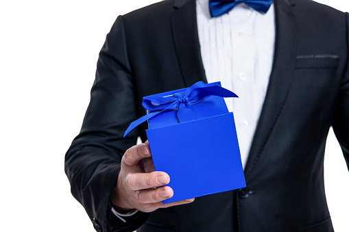 selective focus of occasion present isolated on white background. man with occasion gift in studio. man hold occasion present box. man holding gift for occasion.