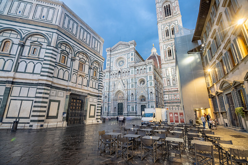People visible in Piazza del Duomo in Florence at Tuscany, Italy. From left to right is Baptistery of St John; Duomo Santa Maria del Fiore; and Giotto's Bell Tower.