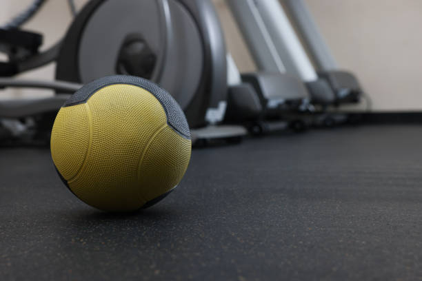 istock Yellow medicine ball on floor in gym, space for text 1452469031