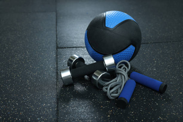 istock Blue medicine ball, dumbbells and skipping rope on floor, space for text 1452469042