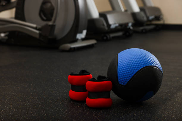 istock Blue medicine ball and ankle weights on floor in gym, space for text 1452469075
