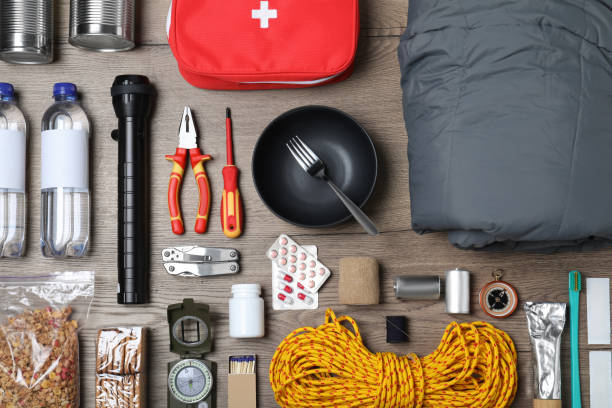 istock Disaster supply kit for earthquake on wooden table, flat lay 1452469750