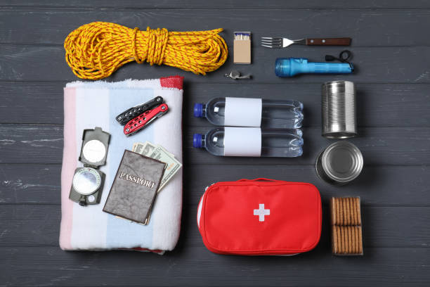 istock Disaster supply kit for earthquake on black wooden table, flat lay 1452469768