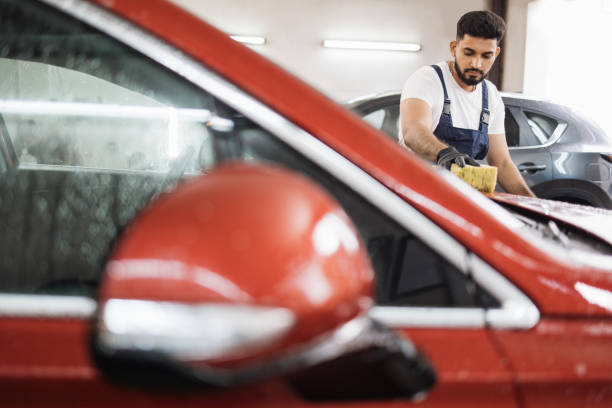 Car wash and clean with shampoo and sponge.