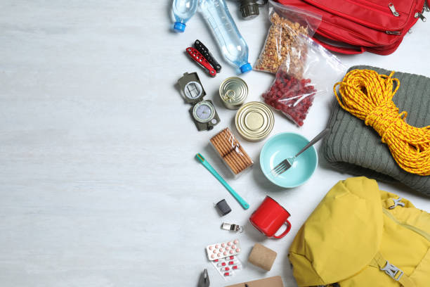 istock Earthquake supply kit on white wooden table, flat lay. Space for text 1452469790
