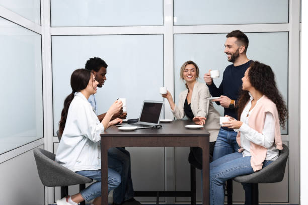 istock Team of employees enjoying coffee break together in office. Startup project 1452470525