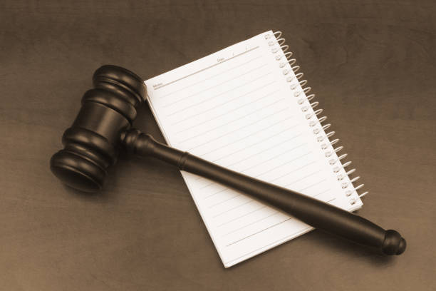 istock Blank note pad with pen and judge gavel on wooden table. 1452470541