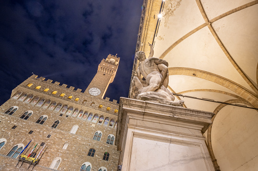 Palazzo Vecchio on Piazza Della Signoria in Florence at Tuscany, Italy, with the Rape of the Sabine Women in the foreground.