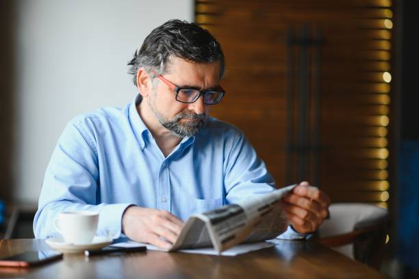 istock Business man reading a newspaper, cafe backgrounds 1452471215