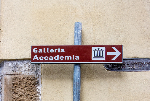 Directional Sign to the commercial art museum known as Galleria Accademia on via Ricasoli in Florence at Tuscany, Italy.