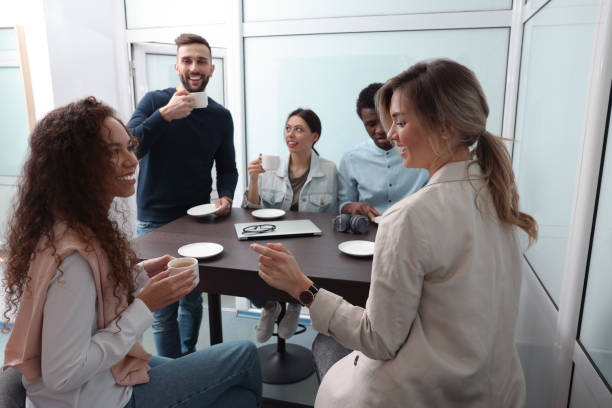 istock Team of employees enjoying coffee break together in office. Startup project 1452471813