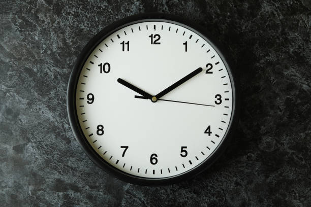 istock Standard black office clock on black smokey background 1452471835