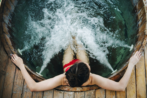 Woman relaxing in the outdoor hot tub