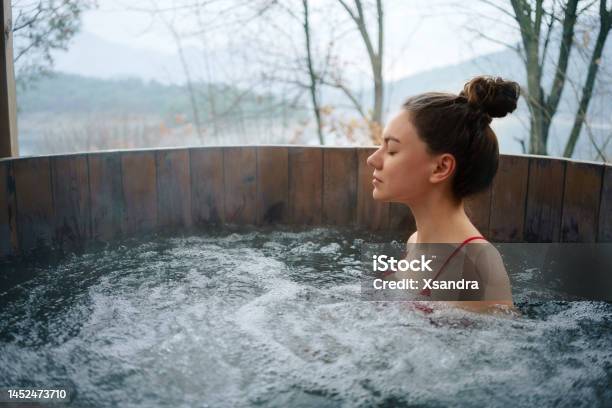 Woman Relaxing In The Outdoor Hot Tub Stock Photo - Download Image Now - Outdoors, Spa, Winter