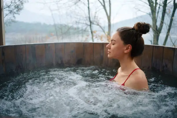 Woman relaxing in the outdoor spa