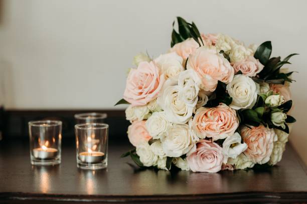 istock Delicate wedding flower bouquet and the lit candles during the ceremony 1452476676