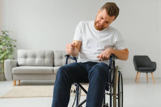 istock Young sad man in a wheelchair at home. 1452477606