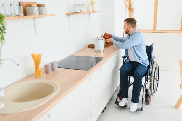istock thoughtful young disabled man on wheelchair at home 1452477994