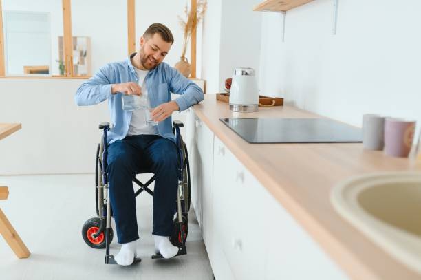 istock Young Disabled Man On Wheelchair In The Kitchen 1452478094