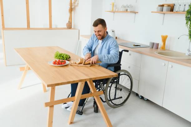 istock thoughtful young disabled man on wheelchair at home 1452478274