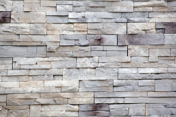 istock Rows of gray and white cut stone blocks for an exterior wall. 1452479325