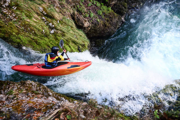 Kayaking over big waterfall Man in red kayak going over a big waterfall. Extreme sports in nature. Danger on river. kayaking stock pictures, royalty-free photos & images