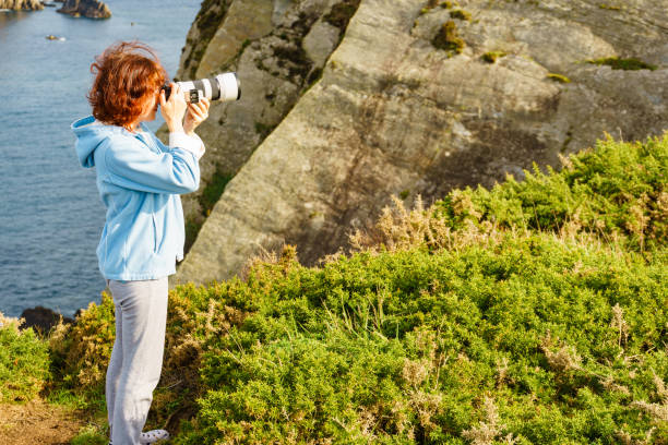 istock Tourist with camera on Asturias coast. Cabo Busto cliffs, Spain. 1452482250