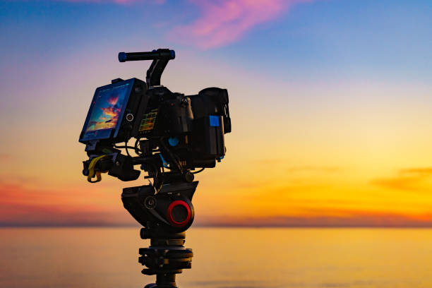 istock Camera taking picture of sunset over sea 1452482567