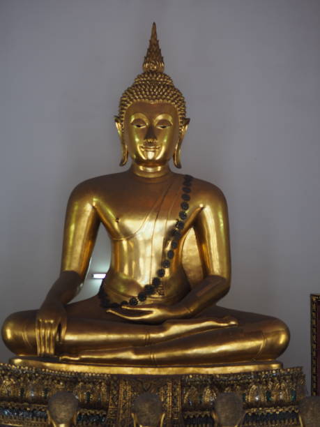 istock Buddha image in yellow gold and gray with white light. 1452482739