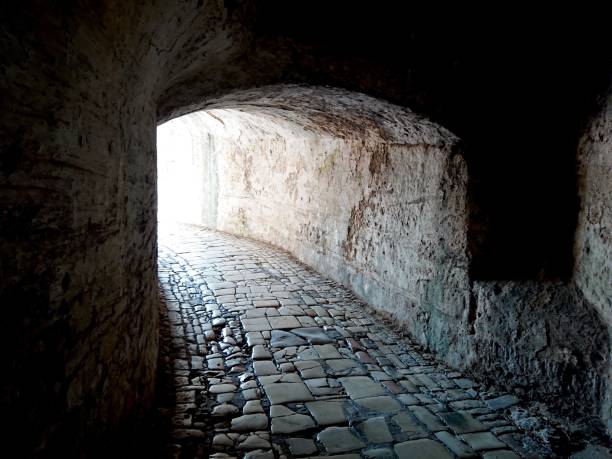 istock Tunnel in an old stone wall extending into a walkway 1452483800