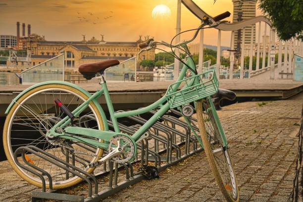 istock Retro beautiful green bicycle parked on a rack in a city 1452484178